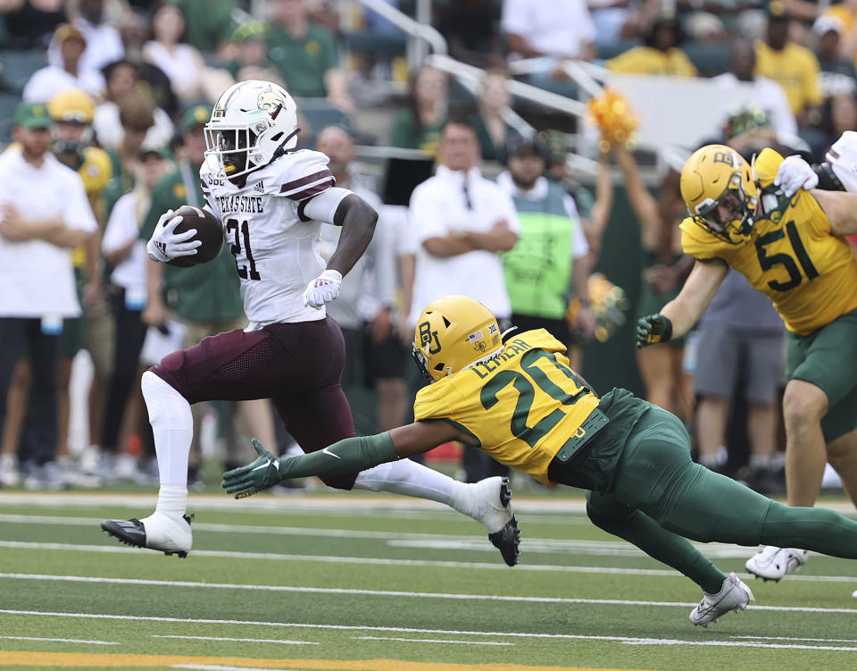 CAPTION CORRECTION CORRECTS DATE: Texas State running back Ismail Mahdi (21) breaks the tackle of Baylor safety Devin Lemear (20) for a touch down in the first half of an NCAA college football game, Saturday, Sept. 2, 2023, in Waco, Texas. (Jerry Larson/Waco Tribune-Herald, via AP)