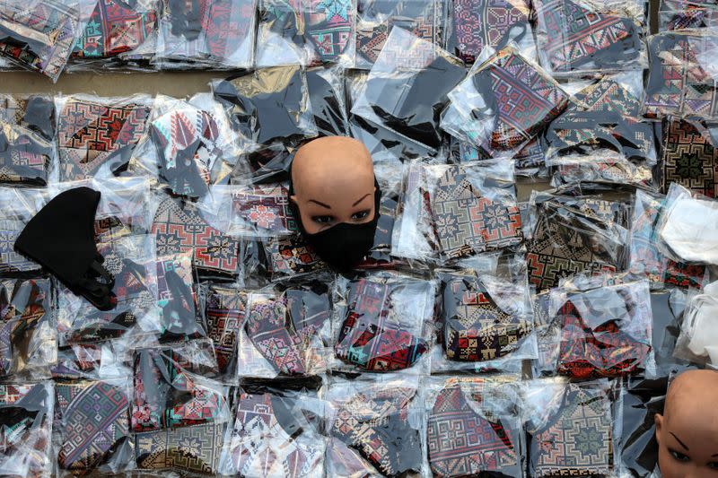 FILE PHOTO: Anti-coronavirus face masks are on display for customers in downtown Amman, Jordan