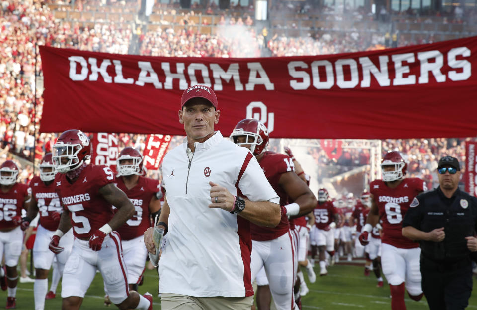 Oklahoma head coach Brent Venables runs onto the field with his team before the start of an NCAA college football game against Iowa State, Saturday, Sept. 30, 2023, in Norman, Okla. (AP Photo/Alonzo Adams)