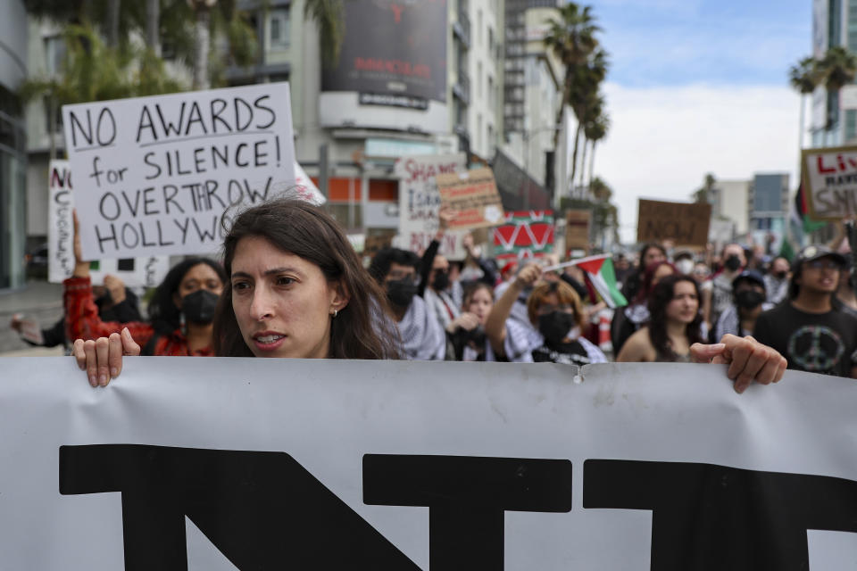 Protesters gather during a demonstration in support of Palestinians calling for a ceasefire in Gaza as the 96th Academy Awards Oscars ceremony is held nearby, Sunday, March 10, 2024, in the Hollywood section of Los Angeles. (AP Photo/Etienne Laurent)