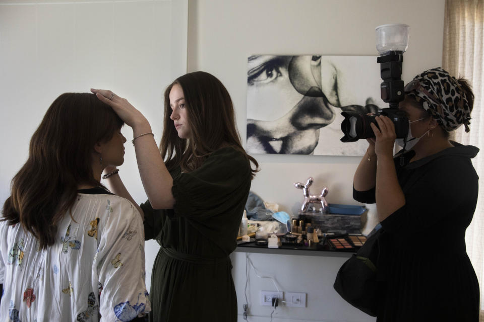 FILE - In this Aug. 26, 2021, file photo, Ultra-Orthodox women prepare for a photoshoot for the subscription-only Jewish Life Photo Bank of what the founder calls “positive” images of Orthodox women for the Chochmat Nashim organization. The idea of the photo bank is to sell images of women that are acceptable to an Orthodox audience, and better understood by people in general. (AP Photo/Sebastian Scheiner, File)