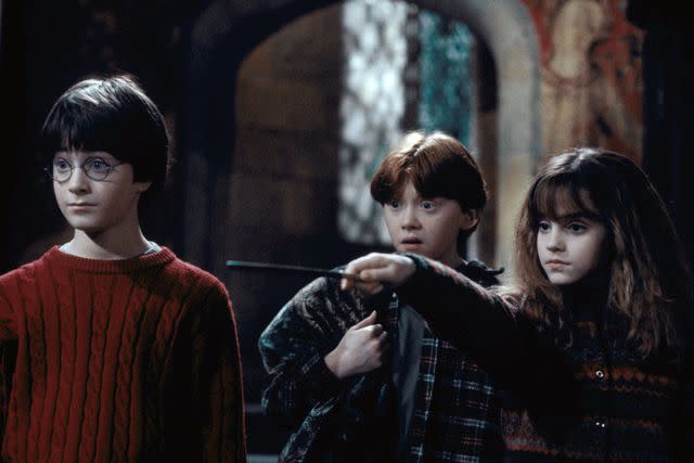 <p>Peter Mountain/ Warner Bros.</p> Daniel Radcliffe, Rupert Grint and Emma Watson in 'Harry Potter and the Sorcerer's Stone,' 2001