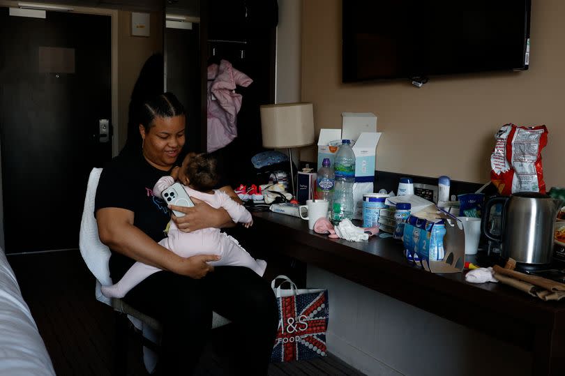 Decoda Smith poses in her hotel with her baby