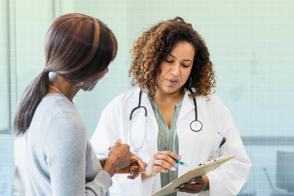 a photo of a doctor reviewing lab results to a patient