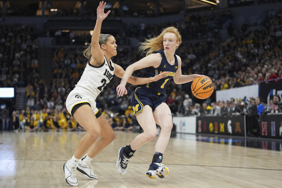 Michigan guard Lauren Hansen (1) works toward the basket as Iowa guard Gabbie Marshall defends during the first half of an NCAA college basketball game in the semifinals of the Big Ten women's tournament Saturday, March 9, 2024, in Minneapolis. (AP Photo/Abbie Parr)