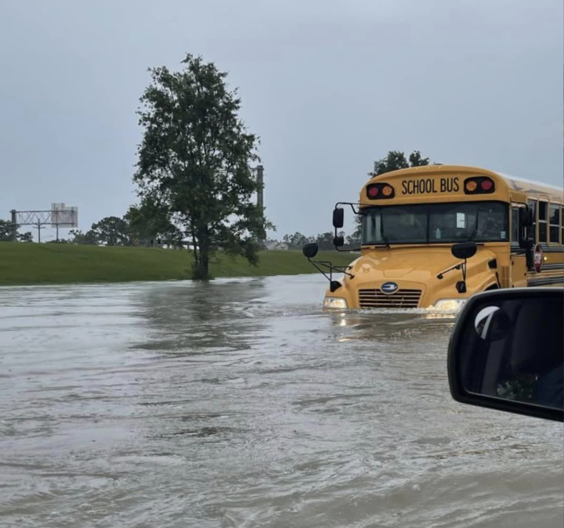 A school bus moves through a flooded street April 10, 2024, in Lake Charles