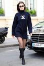 <p>wearing a black sweatshirt minidress by Chanel, sheer tights, casual slouchy boots, and Le Specs x Jordan Askill sunglasses while out in Paris.</p>