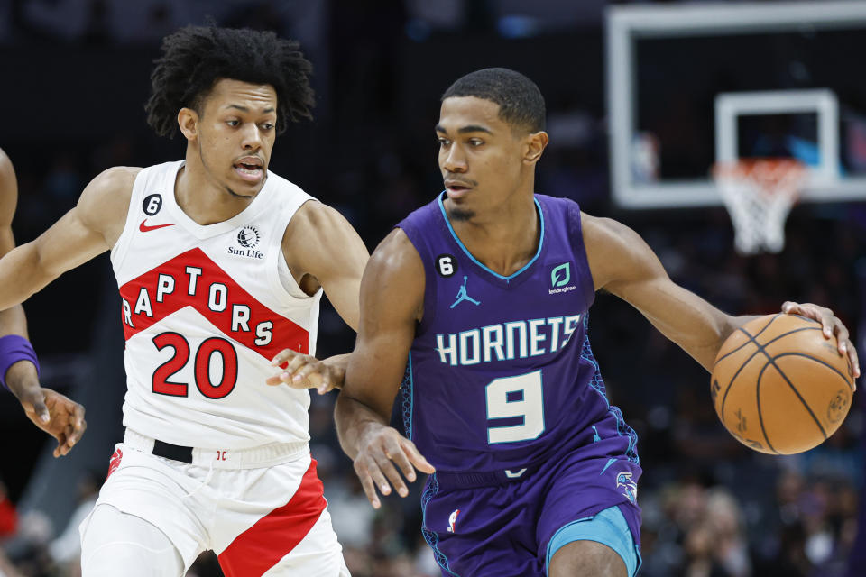 Charlotte Hornets guard Theo Maledon (9) drives past Toronto Raptors guard Jeff Dowtin Jr. during the first half of an NBA basketball game in Charlotte, N.C., Sunday, April 2, 2023. (AP Photo/Nell Redmond)