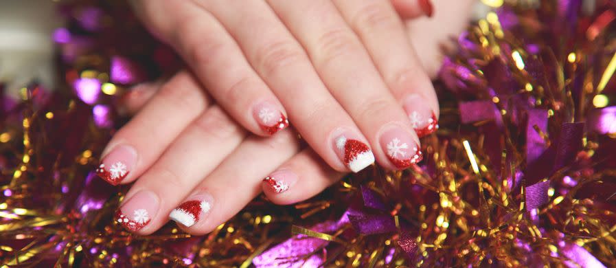 christmas manicure only for holidays with snowflakes and a santa hat as designs
