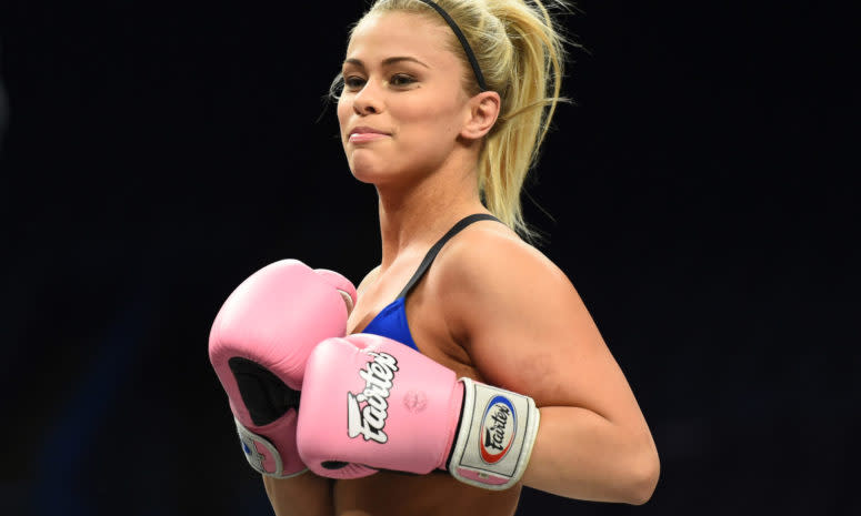 Paige VanZant in the ring with gloves.