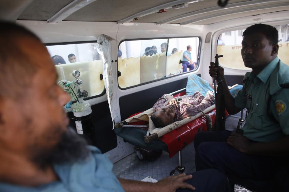 A police ambulance carries a sick prisoner to a court before the verdict for a 2009 mutiny is announced, in Dhaka