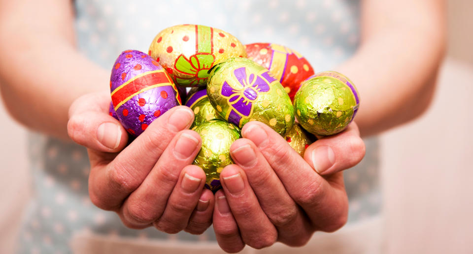 Woman holds Easter eggs in her hands.