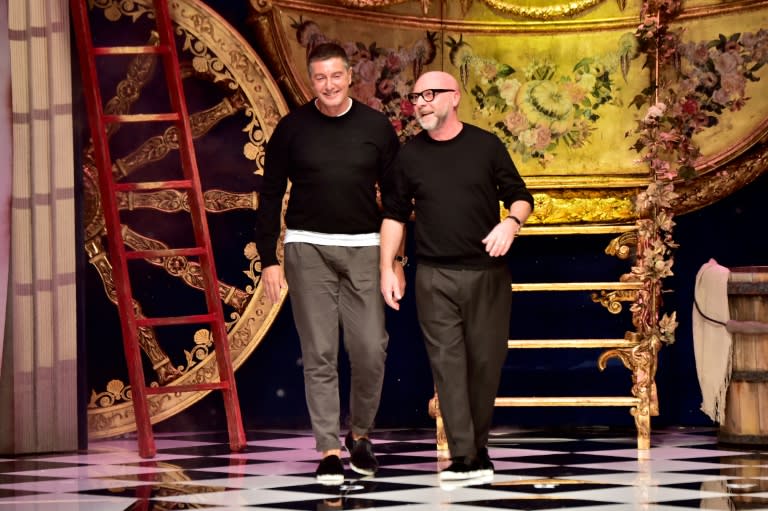 Italian designers Stefano Gabbana (L) and Domenico Dolce greet the audience at the end of their show for Milan Fashion Week on February 28, 2016