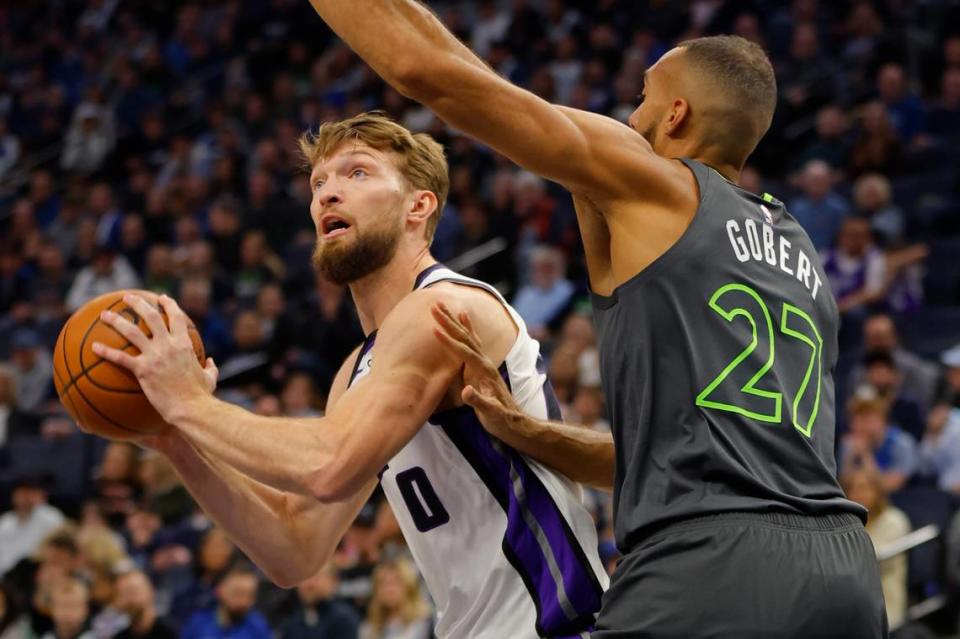 Sacramento Kings center Domantas Sabonis (10) works around Minnesota Timberwolves center Rudy Gobert (27) in the first quarter Friday at Target Center in Minneapolis.