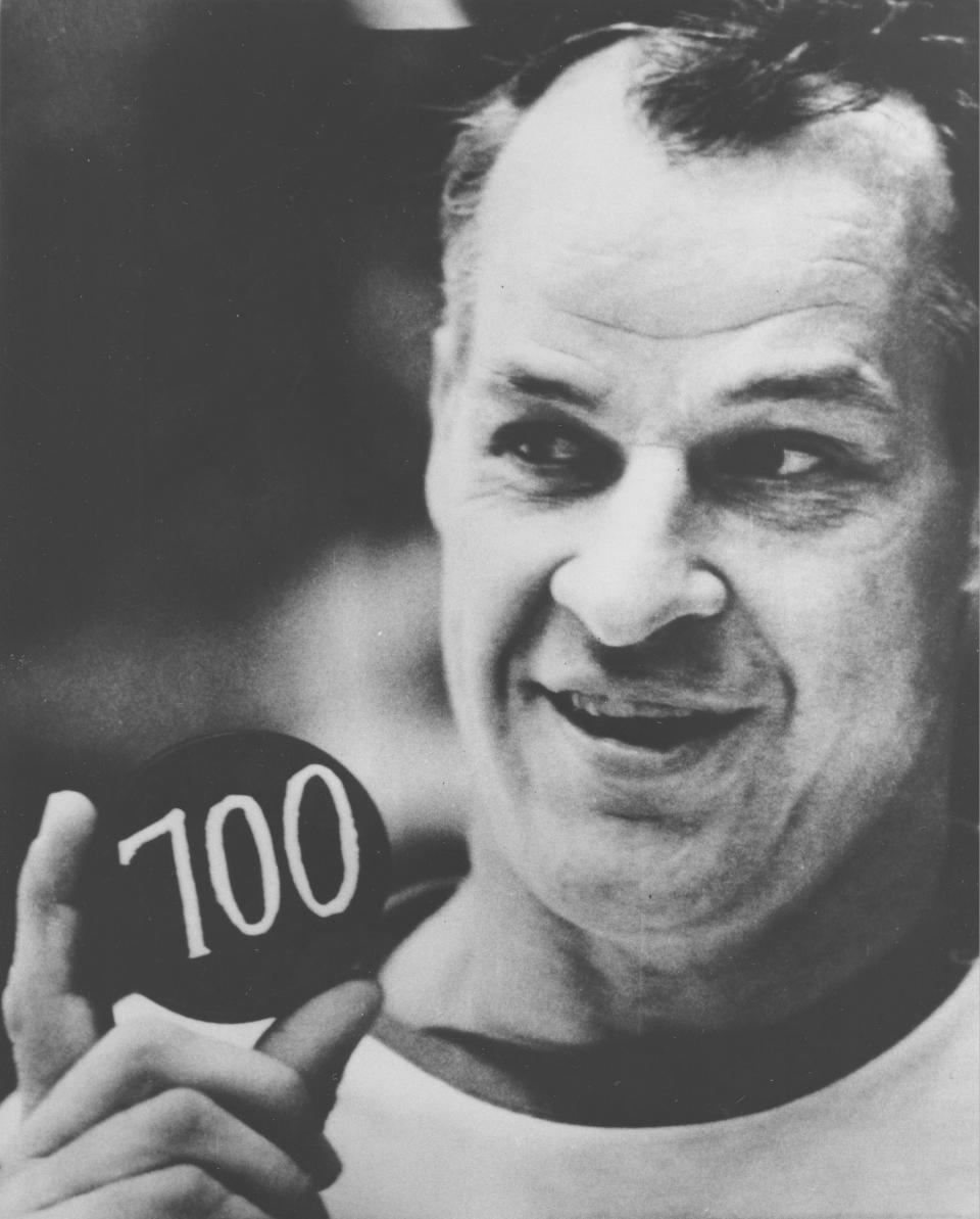 FILE - In this Dec. 5, 1968, file photo, Detroit Red Wings hockey player Gordie Howe displays a hockey puck with the number 700 on it signifying the scoring of his 700th career goal,  in Pittsburgh, Pa. Howe, the rough-and-tumble Canadian farm boy whose boundless blend of talent and toughness made him the NHL’s quintessential star during a career that lasted into his 50s, died Friday. The man forever known as “Mr. Hockey” was 88. (AP Photo/File)