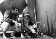 FILE - New York Mets coach Joe Pignatano, right, with pitcher Danny Frisell, left, looks at tomato plants he grew in the baseball bullpen of Shea Stadium in New York, June 25, 1969. Pignatano, who made his major league debut with the Brooklyn Dodgers in 1957 and later was a coach for the Mets, died Monday, May 23, 2022, in Naples, Fla. (AP Photo/Harry Harris)