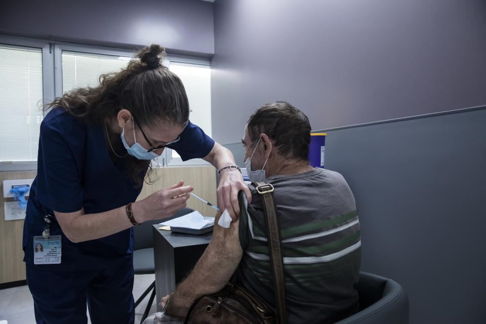 RAMAT GAN, ISRAEL - JULY 14:  A man receives his third dose of COVID19 vaccine at Sheba Medical Center on July 14, 2021 in Ramat Gan, Israel. This week the country started offering third doses of the Pfizer Covid-19 vaccine to adults with weak immune systems, due to concern about the more virulent Delta variant.  (Photo by Amir Levy/Getty Images)