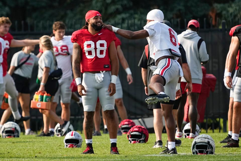 Aug 8, 2024; Columbus, Ohio, USA; Ohio State Buckeyes tight end Gee Scott Jr. (88) and safety Sonny Styles (6) stretch during football practice at the Woody Hayes Athletic Complex.