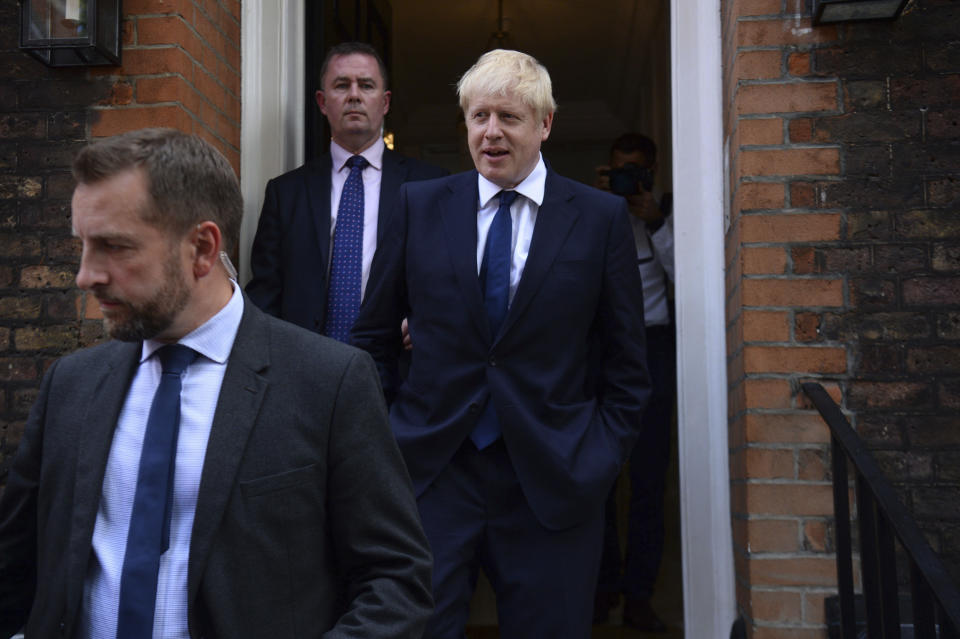 Conservative Party leadership contender Boris Johnson, right, leaves his office in London, Monday July 22, 2019.  Voting closes Monday in the ballot to elect Britain's next prime minister, from the two contenders Jeremy Hunt and Boris Johnson, as critics of likely winner Boris Johnson condemned his vow to take Britain out of the European Union with or without a Brexit deal.(Kirsty O'Connor/PA via AP)
