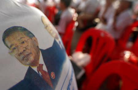 A supporter of the Cambodian People's Party (CPP), wears a T-shirt with a portrait of CPP president and Cambodia Prime Minister Hun Sen during a senate election campaign at the Freedom Park in Phnom Penh, Cambodia February 23, 2018. REUTERS/Samrang Pring
