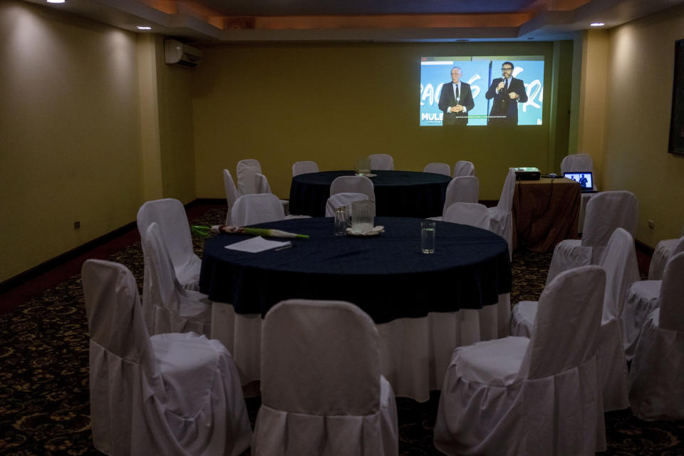 A TV screen projects a live stream of Edmond Mulet, presidential candidate of the Cabal party and his running mate Max Santa Cruz, to an empty press room in Guatemala City, Thursday, June 22, 2023. Guatemalans go to the polls on June 25. (AP Photo/Moisés Castillo)