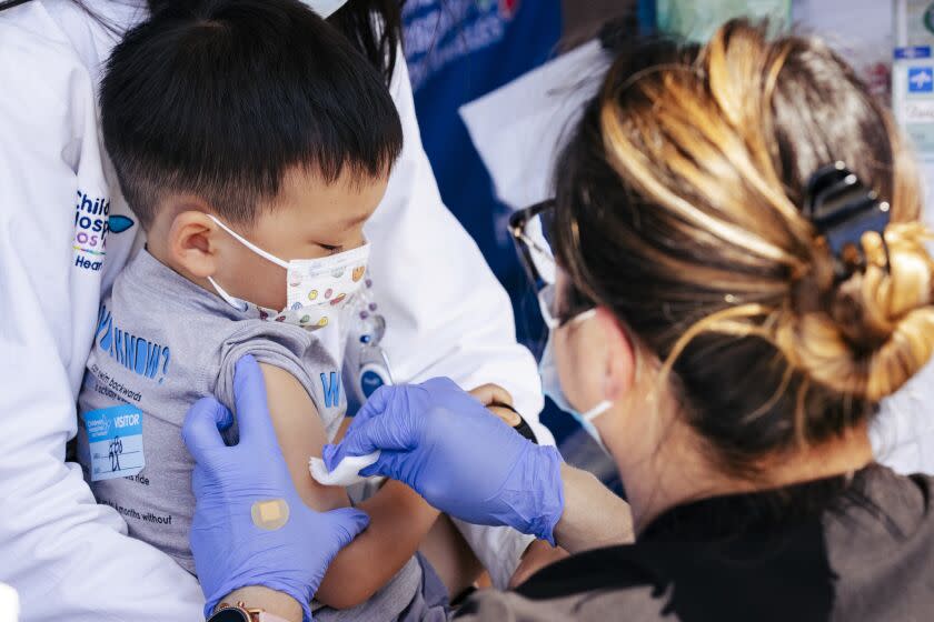 Los Angeles, CA - June 21: Children's Hospital Los Angeles nurse Monica Lopez prepares to administer the Pfizer COVID-19 vaccine to Callum Diaz-Cheng, 3, son of CHLA Cardiologist Dr. Jennifer Su and one of the hospital's first children under five to receive the shot, on Tuesday, June 21, 2022 in Los Angeles, CA. (Wesley Lapointe / Los Angeles Times)