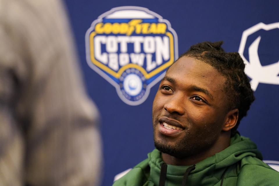 Tulane running back Tyjae Spears (22) speaks during a news conference for the Cotton Bowl NCAA college football game, Thursday, Dec. 29, 2022, in Arlington, Texas. Tulane faces Southern California in the Cotton Bowl on Monday, Jan. 2, 2023. (AP Photo/Sam Hodde)