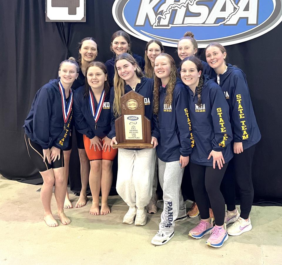 Notre Dame Pandas pose with their fourth-place team trophy during the KHSAA state girls swimming championships Feb. 24, 2024 at the University of Kentucky's Lancaster Aquatic Center.