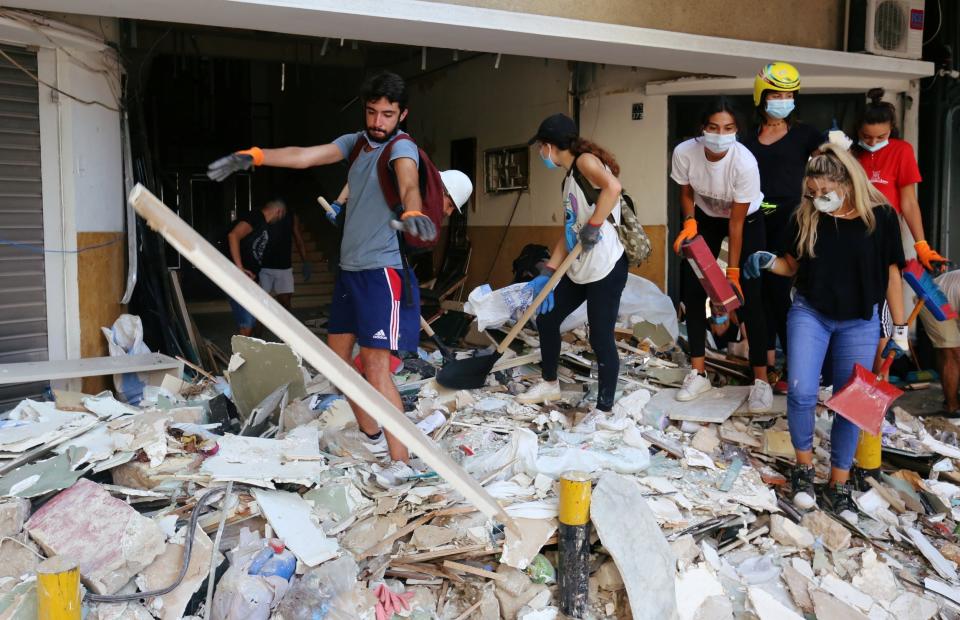 Volunteers clean rubble from the streets: REUTERS