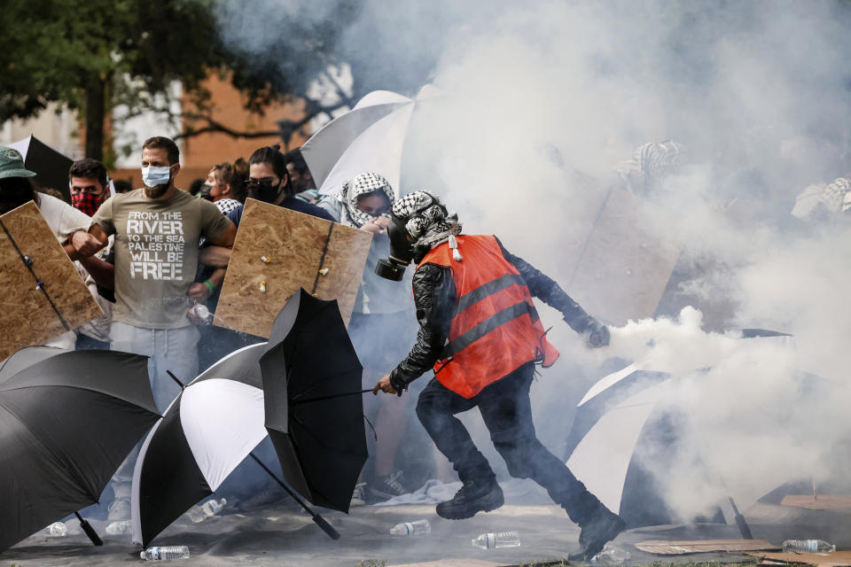 FILE - A pro-Palestinian protester returns a tear-gas canister toward police after it tumbled into a congregation of protesters at MLK Plaza at the University of South Florida, on April 30, 2024, in Tampa, Fla. Israeli Prime Minister Benjamin Netanyahu has repeatedly accused critics of Israel or his policies of antisemitism, including the U.S. college campus protests and the prosecutor of the International Criminal Court. (Douglas R. Clifford/Tampa Bay Times via AP, File)