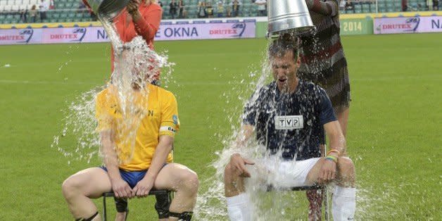 WARSAW, POLAND - AUGUST 31: (SOUTH AFRICA AND POLAND OUT)  Piotr Krasko, captain of TVP's team and Kamil Durczok, captain of TVN's team take part in the 'Ice Bucket Challenge aided by Agata Mlynarska and Agnieszka Szulim during the friendly football match between TVP and TVN on August 31, 2014 in Warsaw, Poland. The teams were captained by the leading news presenters of each network while the game was refereed by the former goal keeper of Poland's National Team. All money raised from ticket sales was donated to the Children's Hospital in Lodz for the renovation of the clinic.  (Photo by Adam Jagielak/Getty Images Poland/Getty Images) (Photo: )
