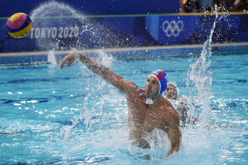 Italy's Pietro Figlioli (4) shoots during a preliminary round men's water polo match against the United States at the 2020 Summer Olympics, Thursday, July 29, 2021, in Tokyo, Japan. (AP Photo/Mark Humphrey)