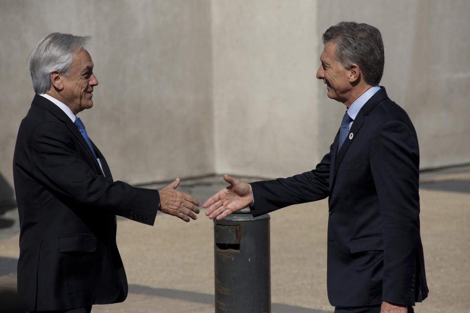 Chile's President Sebastian Pinera receives Argentina's President Mauricio Macri at La Moneda, presidential palace in Santiago, Chile, Friday, March 22, 2019. South American heads of state are meeting in Santiago to discuss the development of a new regional political bloc called Prosur, the idea being to replace the Unasur, the current body that many describe as defunct. (AP Photo/Esteban Felix)