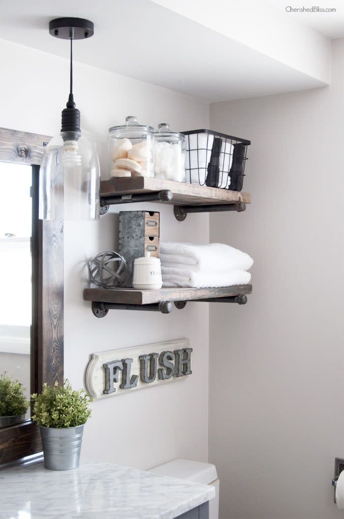 bathroom shelf ideas, bathroom with two dark wood shelved with toiletries and jars