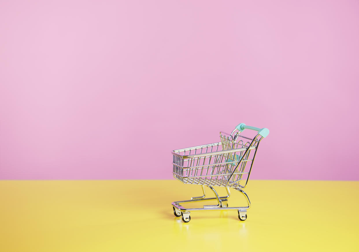 toy shopping trolley with pink  and yellow background