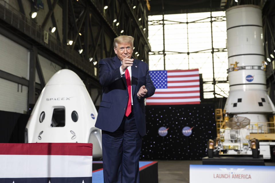 President Donald Trump points to Elon Musk as he arrives to speak after viewing the SpaceX flight to the International Space Station, at Kennedy Space Center, Saturday, May 30, 2020, in Cape Canaveral, Fla. (AP Photo/Alex Brandon)