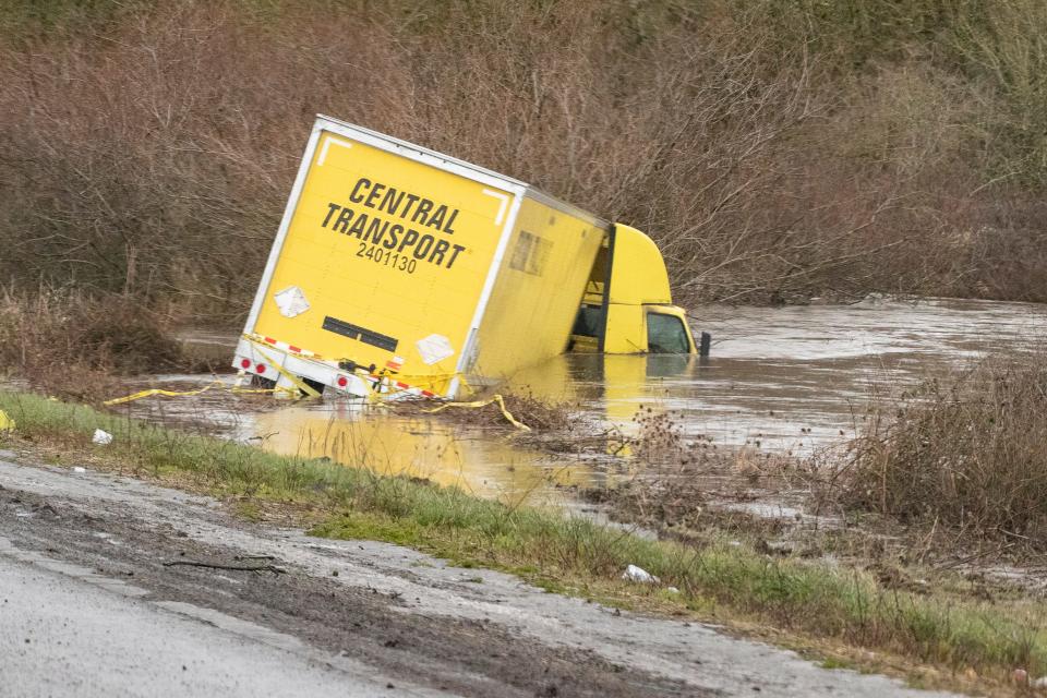 A semitruck sits in a roadside pond near milepost 210 on Interstate 5 during a winter storm Jan. 17 in Oregon