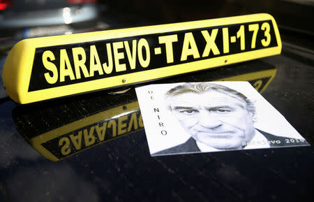 Poster of Robert De Niro is seen on the cab in tribute to the actor who will open the city's film festival on Friday with a screening of "Taxi Driver" in Sarajevo, Bosnia and Herzegovina, August 12, 2016. REUTERS/Dado Ruvic