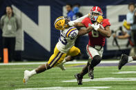 LSU linebacker Micah Baskerville (23) drags Georgia running back Kenny McIntosh (6) down in the second half of the Southeastern Conference Championship football game Saturday, Dec. 3, 2022 in Atlanta. (AP Photo/John Bazemore)