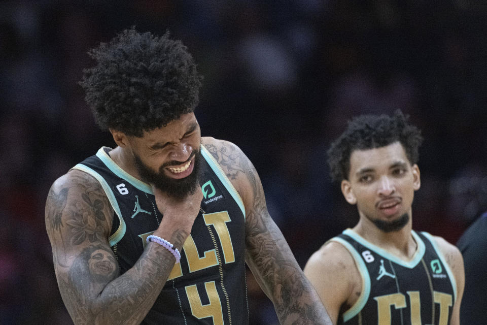 Charlotte Hornets' Nick Richards (4) grimaces after an injury as James Bouknight watches during the second half of an NBA basketball game against the Cleveland Cavaliers in Cleveland, Sunday, April 9, 2023. (AP Photo/Phil Long)