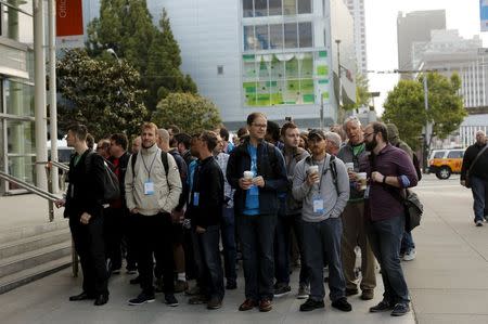 Conference attendees wait at the entrance to Microsoft Build in San Francisco, California April 29, 2015. REUTERS/Robert Galbraith