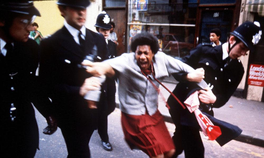 Police arrest a woman in the Brixton riots of 1981