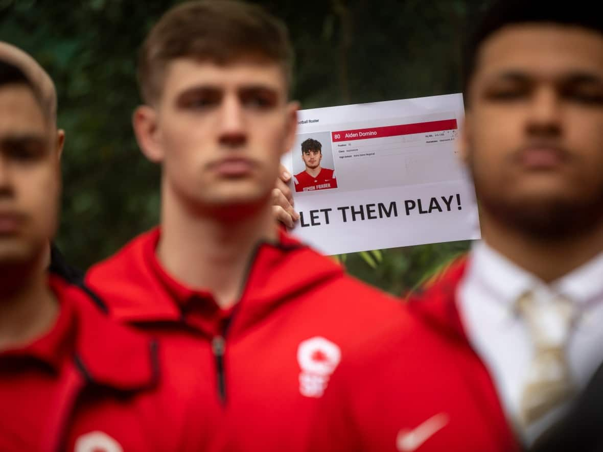 Alumni and supporters of the Simon Fraser Football program are pictured outside of the courthouse in Vancouver, British Columbia on Thursday, April 13, 2023.  (Ben Nelms/CBC - image credit)