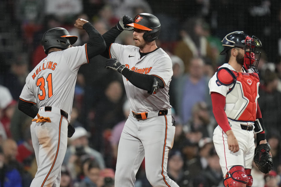 Baltimore Orioles' Jordan Westburg, center, is congratulated by Cedric Mullins (31) after his three-run home run in the seventh inning of a baseball game against the Boston Red Sox, Wednesday, April 10, 2024, in Boston. At right is Red Sox catcher Connor Wong. (AP Photo/Charles Krupa)