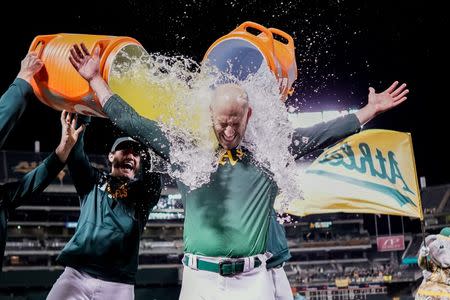 May 7, 2019; Oakland, CA, USA; Oakland Athletics starting pitcher Mike Fiers (50) is dunked after pitching a no hitter against the Cincinnati Reds at Oakland Coliseum. Mandatory Credit: Stan Szeto-USA TODAY Sports