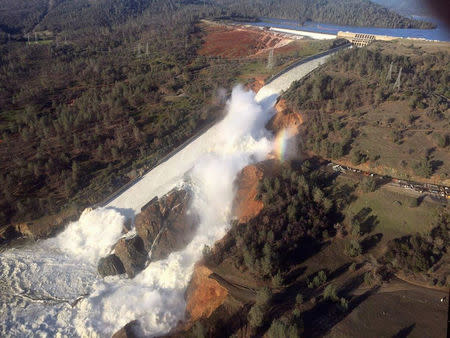 A damaged spillway with eroded hillside is seen in an aerial photo taken over the Oroville Dam in Oroville, California. California Department of Water Resources/William Croyle/Handout via REUTERS