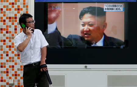 A man walks past a street monitor showing North Korea's leader Kim Jong-Un in a news report about North Korea's nuclear test, in Tokyo, Japan, September 3, 2017. REUTERS/Toru Hanai