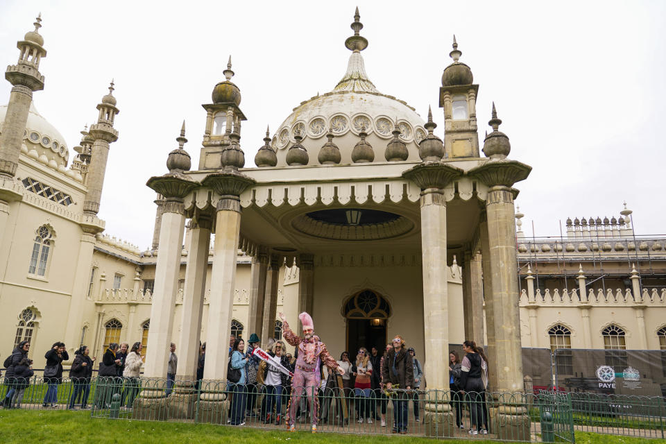 People dressed in costumes take part in a silent disco event outside the Brighton Dome, in Brighton, England, Saturday, April 6, 2024. Fans are celebrating 50 years since ABBA won its first big battle with “Waterloo.” A half century ago on Saturday, April 6, the Swedish quartet triumphed at the 1974 Eurovision Song Contest with the peppy love song. (AP Photo/Alberto Pezzali)