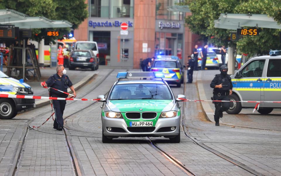 A street is cordoned off and lined with police cars - Karl-Josef Hildenbrand/dpa