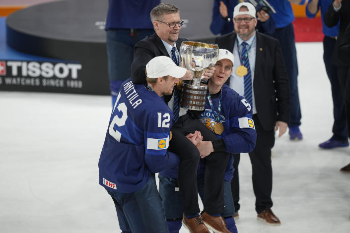 Finland's head coach Jukka Jalonen is hoisted in the air with the Gold medal trophy after the Hockey World Championship final match between Finland and Canada, Sunday May 29, 2022, in Tampere, Finland. Finland won 4-3 in overtime. (AP Photo/Martin Meissner)
